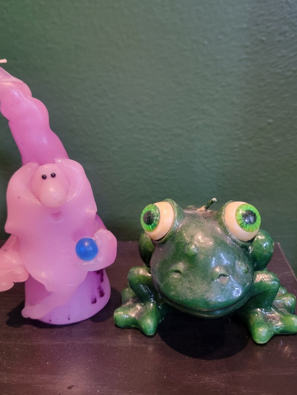 green frog candle and pink wizard candle